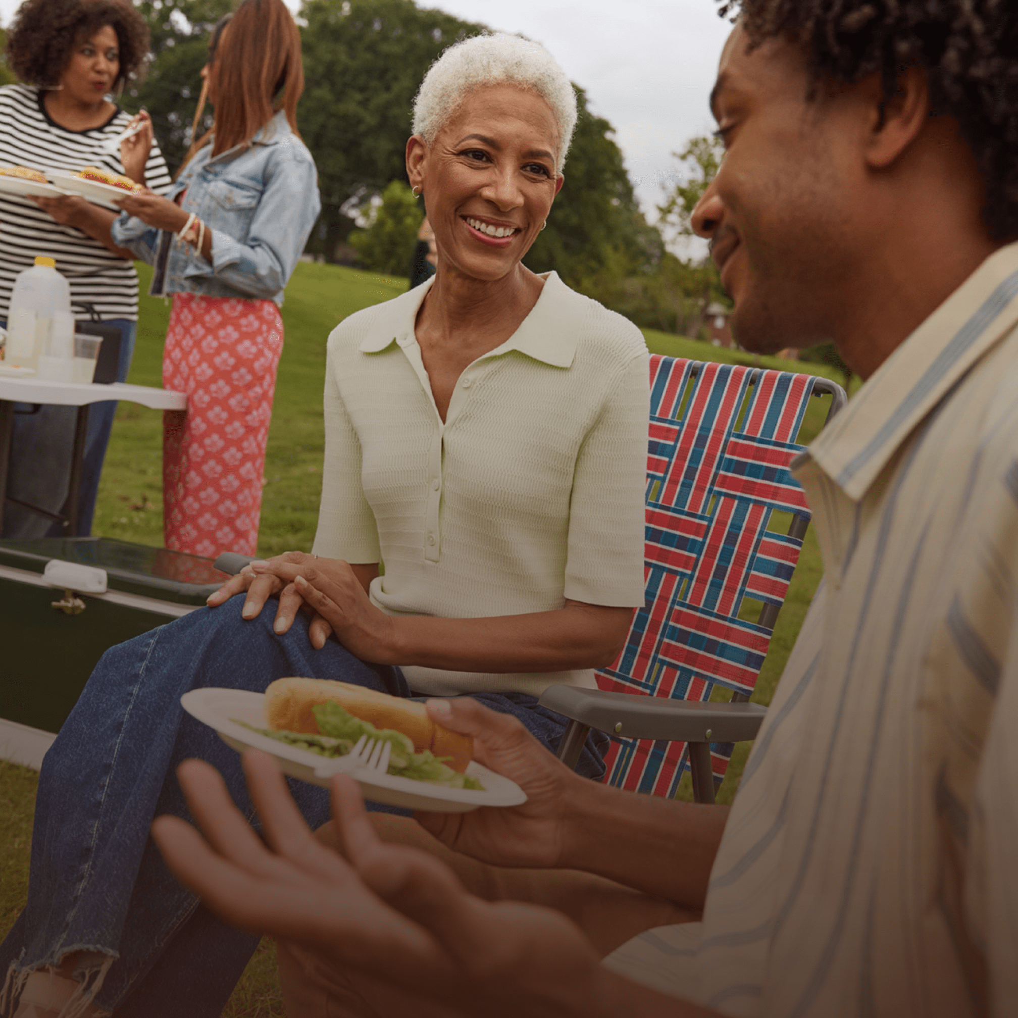 Two Black women are talking at the park.