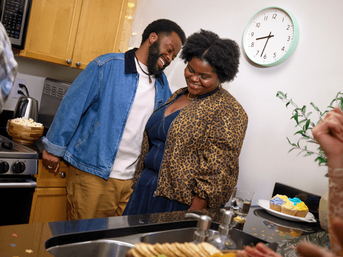 Black couple in the kitchen 
talking.
